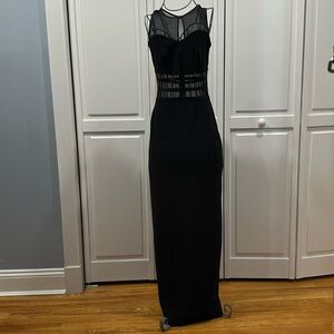 Sleeveless knit long black dress with back slit and mesh inserts